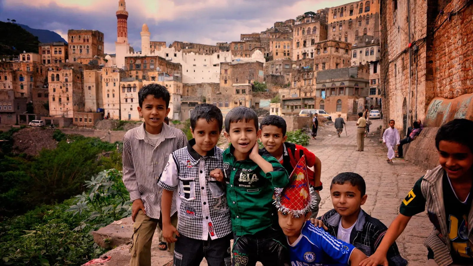 A group of young boys smiling in the old town of Jibla, Yemen